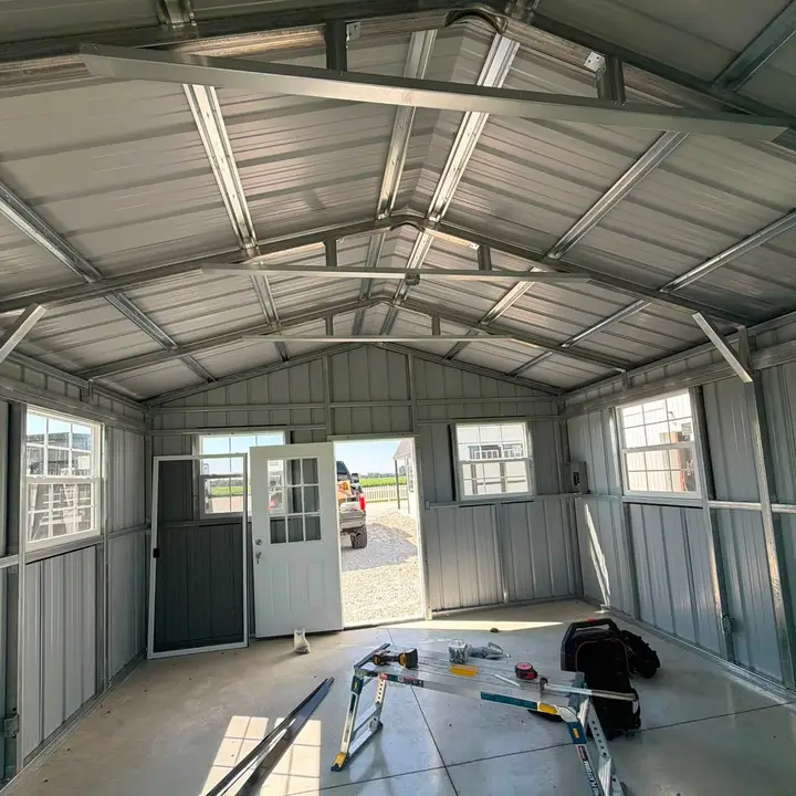 The interior of a newly built steel building, with a finished vaulted ceiling and windows fitted.